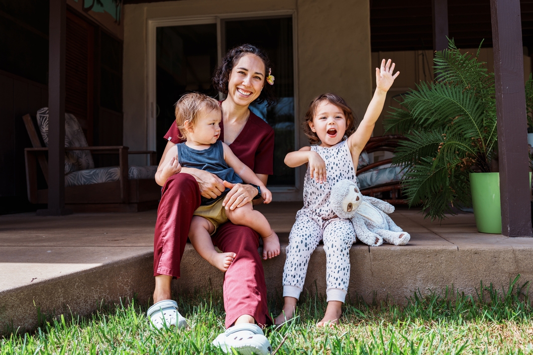 Children playing outside with mom