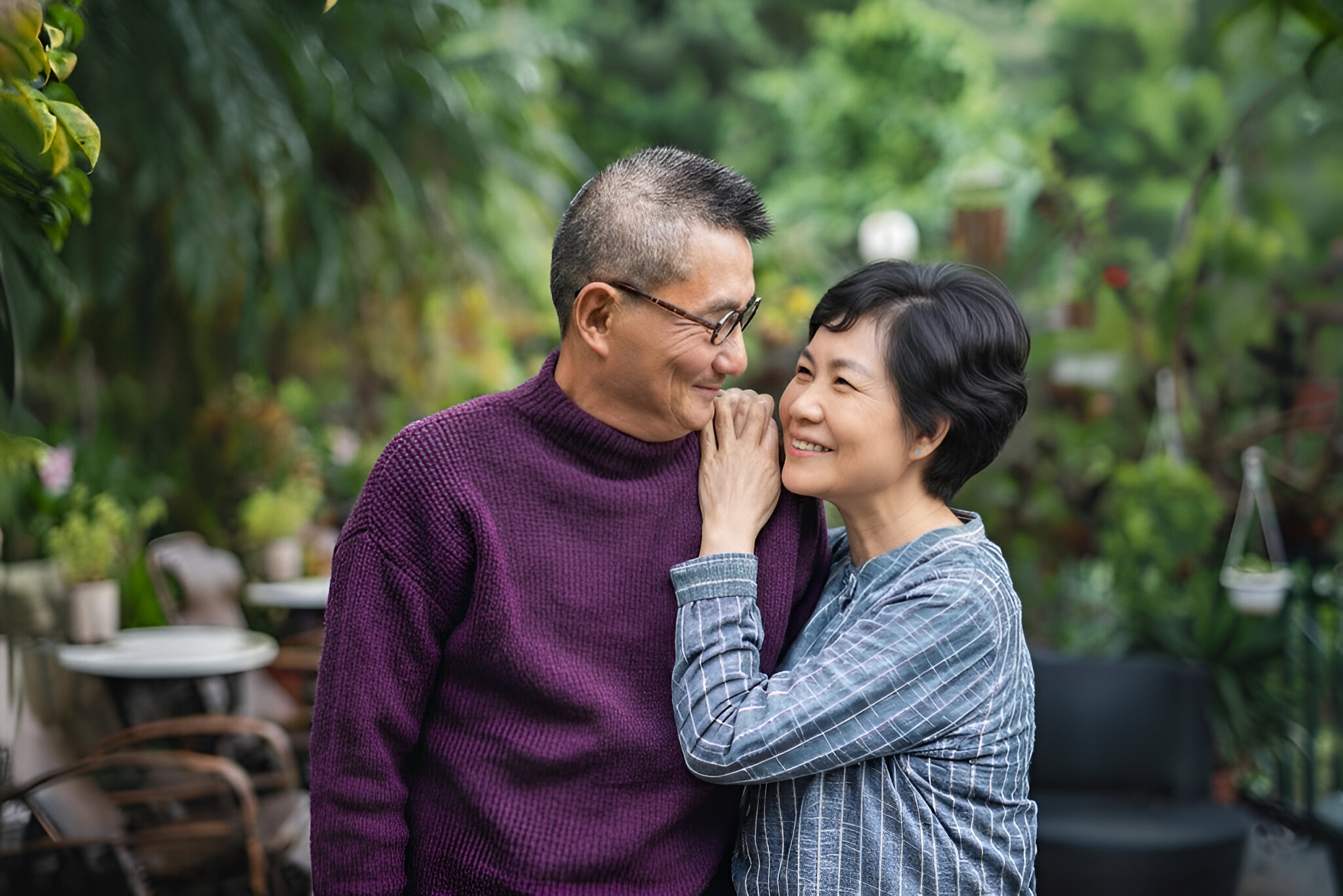 Grandfather and grandchild picking blueberries