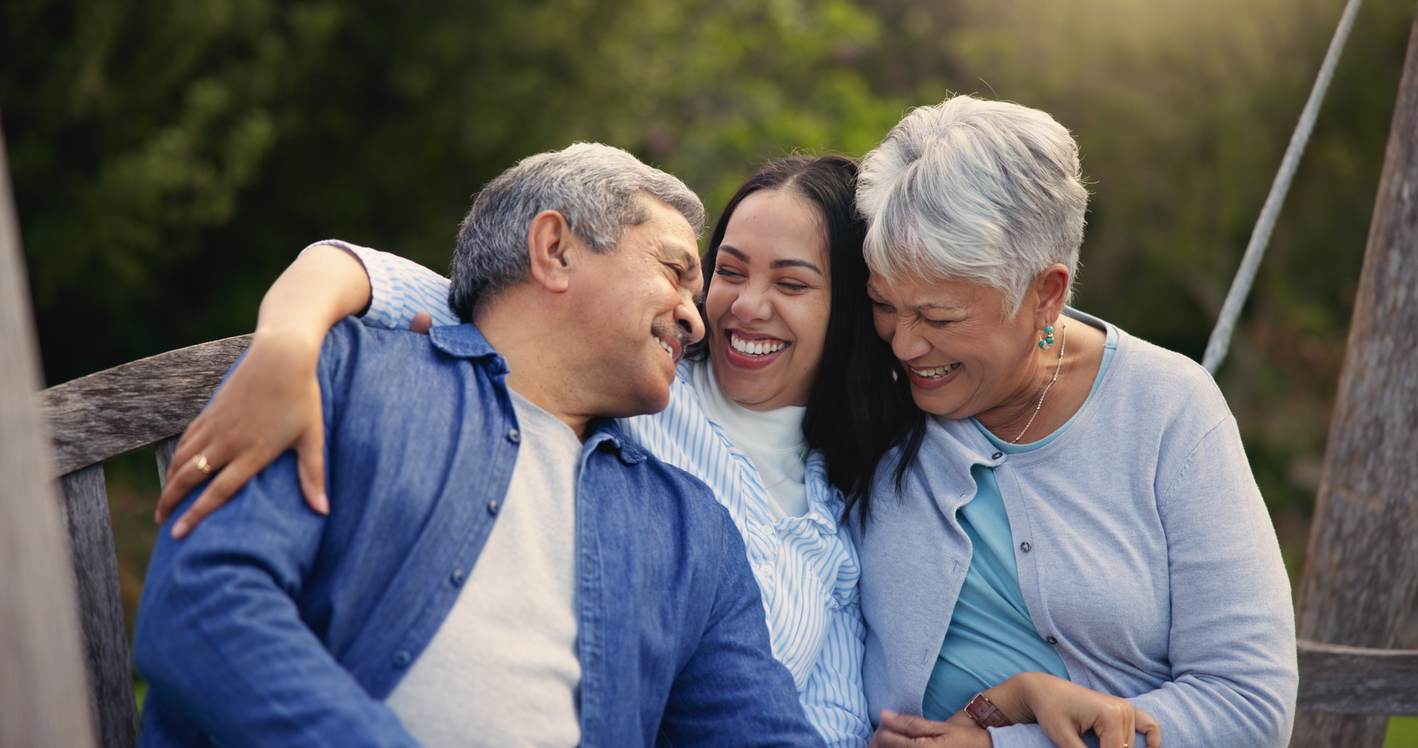 Senior family hugging on bench